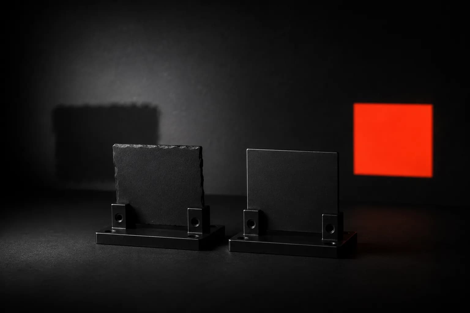 Two mounted black nameplates: the roughly cut one casts a broken grey silhouette while the precisely machined one projects a sharp orange rectangle β a metaphor for refreshing titles, meta descriptions, and on-page structure until underperforming pages start moving Two mounted black nameplates: the roughly cut one casts a broken grey silhouette while the precisely machined one projects a sharp orange rectangle β a metaphor for refreshing titles, meta descriptions, and on-page structure until underperforming pages start moving